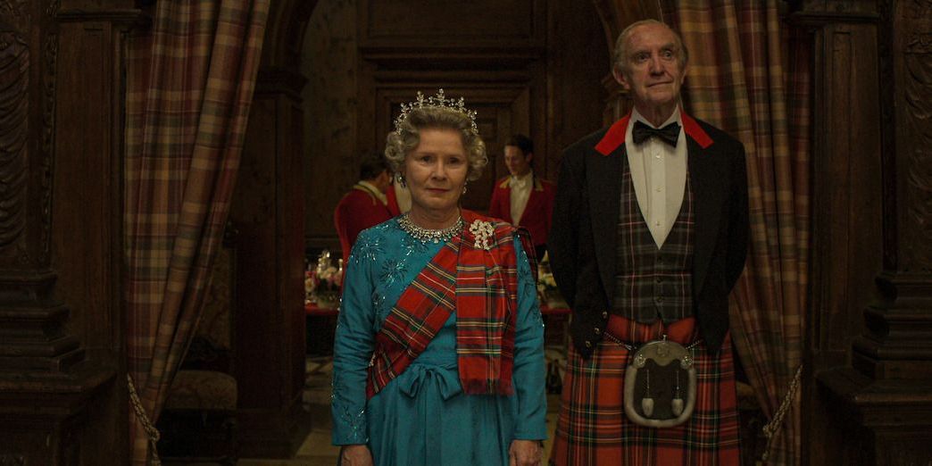 Queen Elizabeth II and Prince Philip walking into a ballroom in The Crown season 5