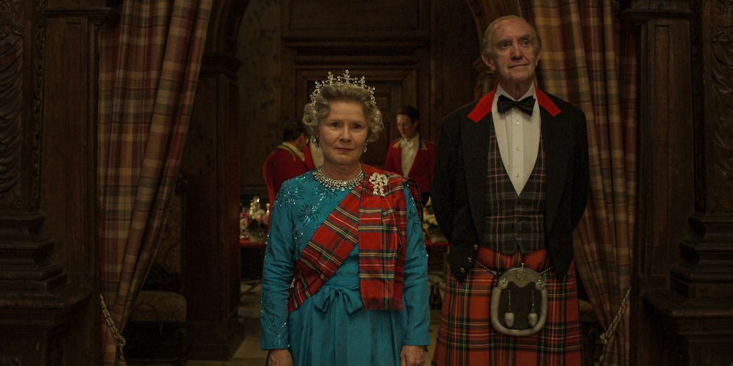Queen Elizabeth II and Prince Philip walking into a ballroom in The Crown season 5 