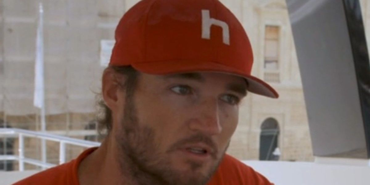 Jason Gaskell wearing a red hat with a white H