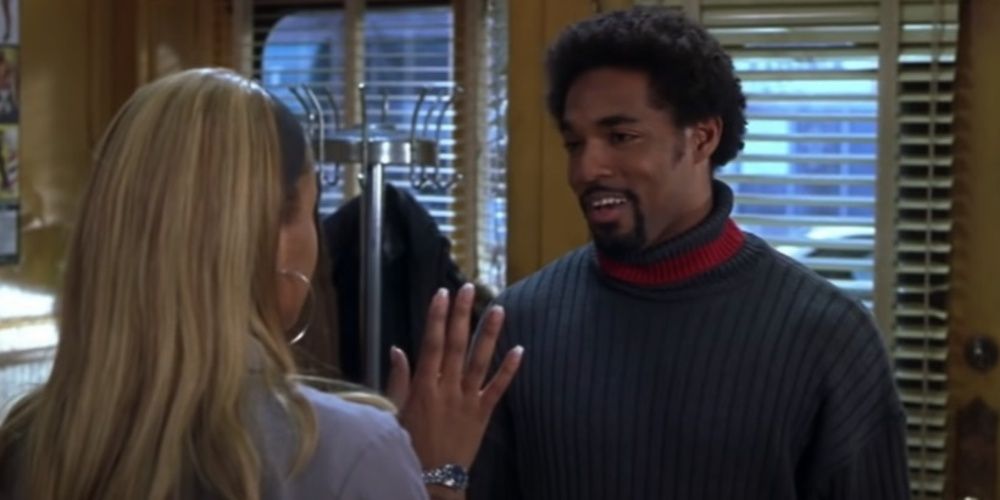 Jason George talking to his girlfriend in a barbershop in Barbershop
