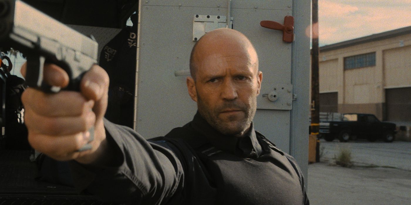 Jason Statham como Patrick "H" Hill/Mason Hargreaves segura uma arma em Wrath of Man.