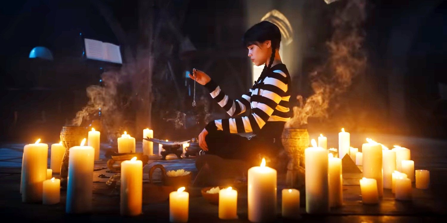 Jenny Ortega as Wednesday Addams sitting in a circle of lit candles