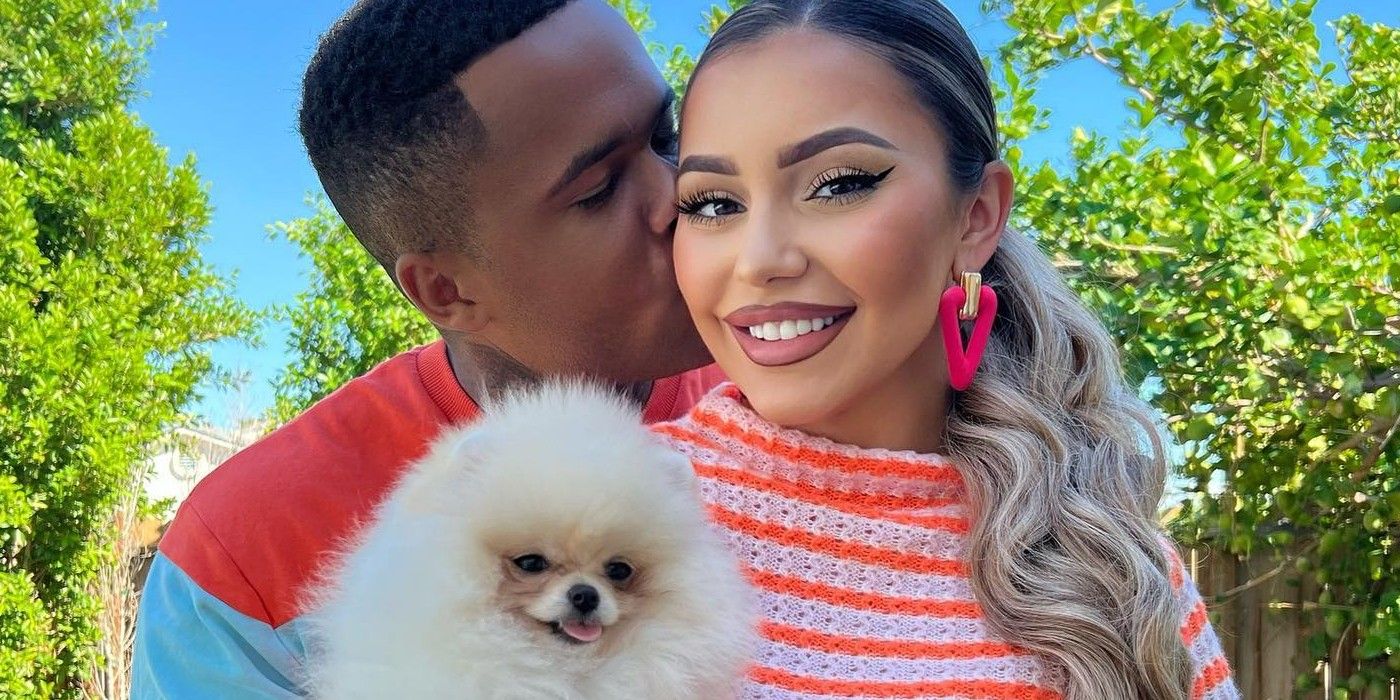 90 Day Fiancé stars Jibri and Miona Bell cuddling with their dog wearing bright colors smiling