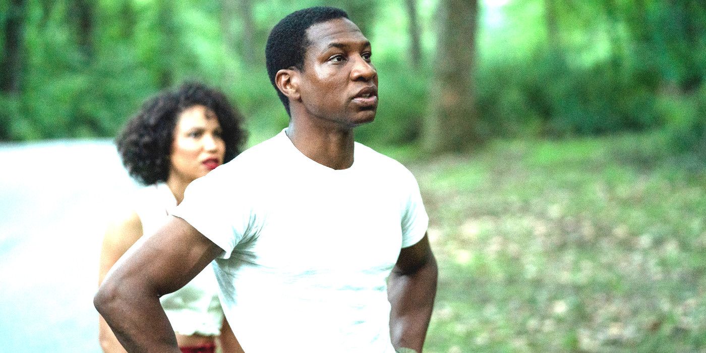 Jonathan Majors in Lovecraft Country in a white t-shirt by the side of the road looking serious