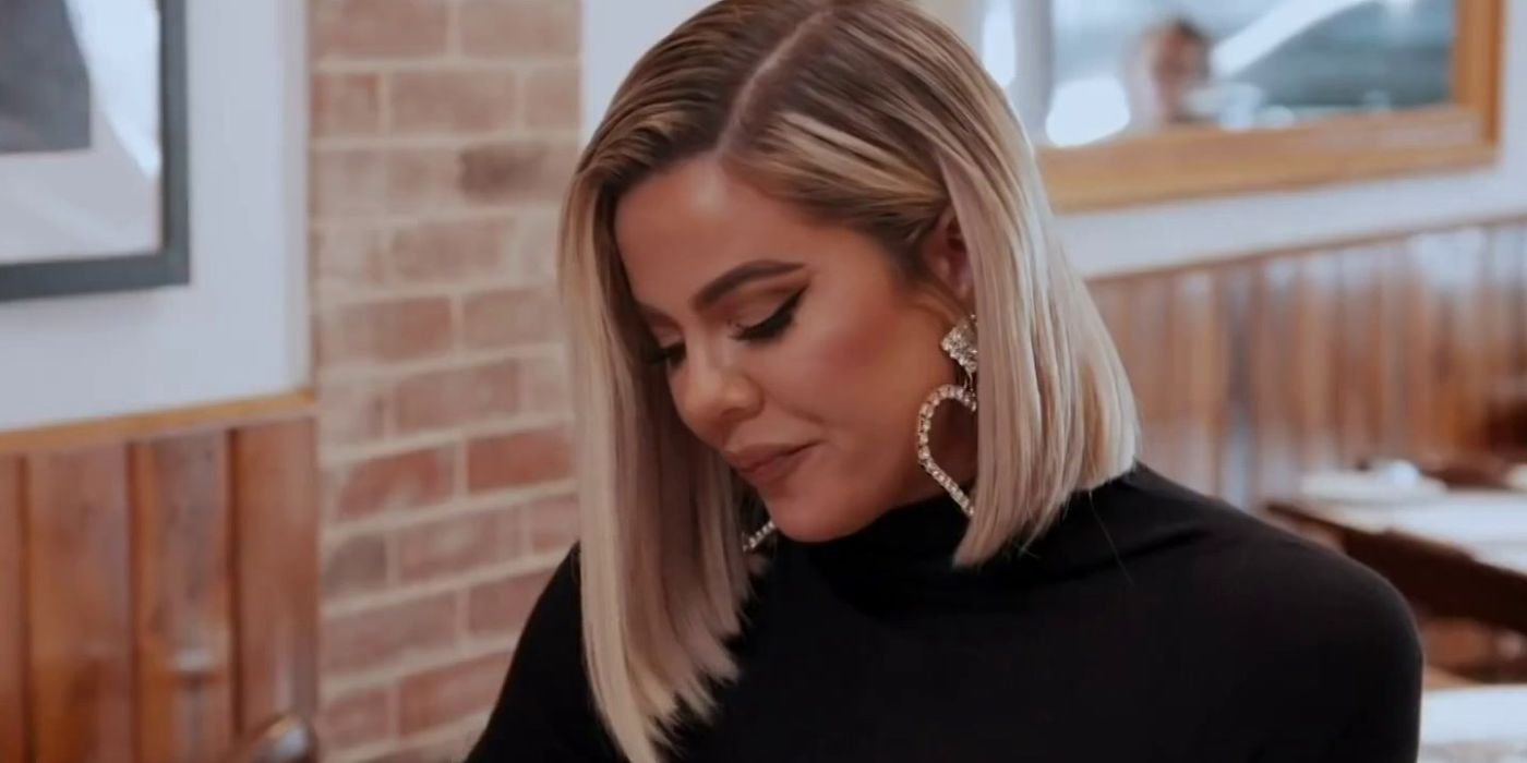 Khloe looks down at her plate on KUWTK