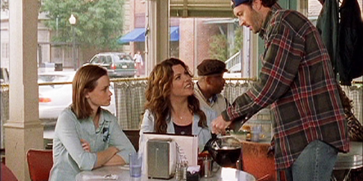 Luke pouring coffee for Rory and Lorelai in Gilmore Girls. 