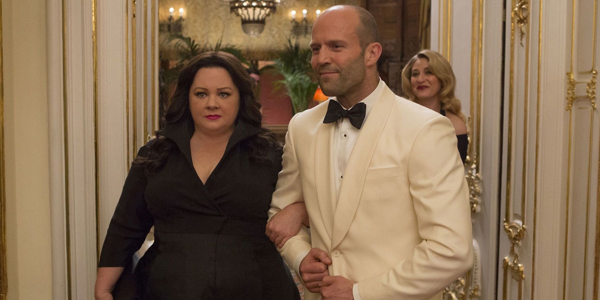 Melissa McCarthy and Jason Statham link arms in Spy