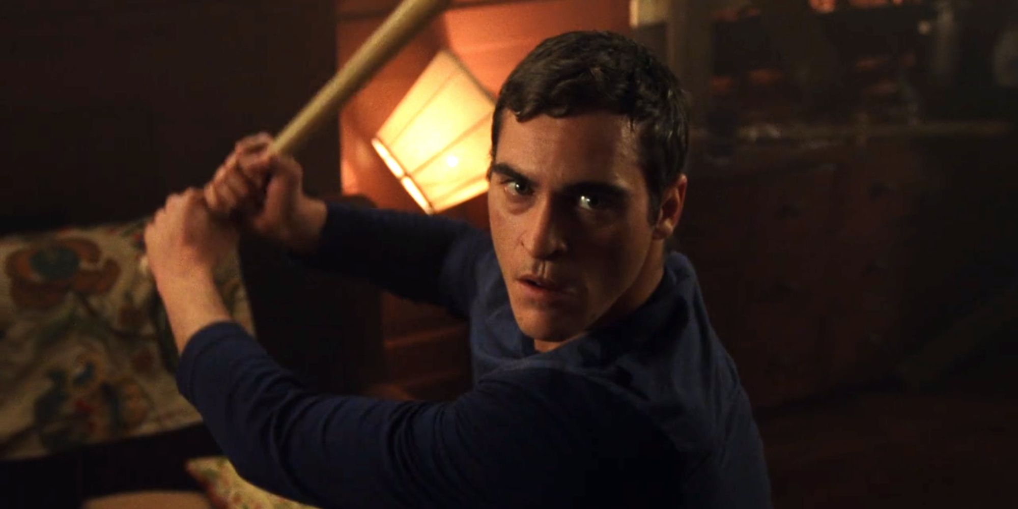 Merrill Hess (Joaquin Phoenix) wielding his baseball bat against the alien in Signs (2002)