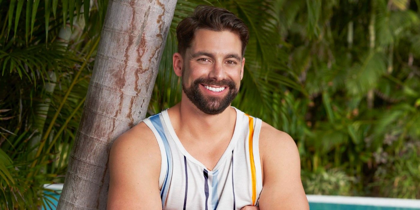 Michael Allio on Bachelor in Paradise wearing striped tank top posing near tree
