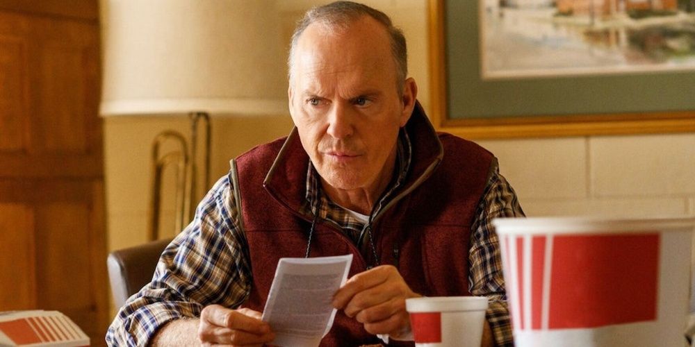 Michael Keaton holding a piece of paper in Dopesick