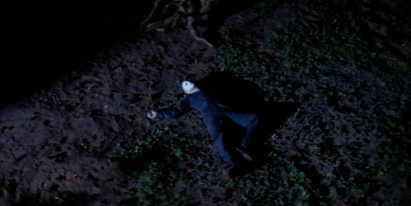 Michael Myers sprawls on the ground after falling off the roof in Halloween