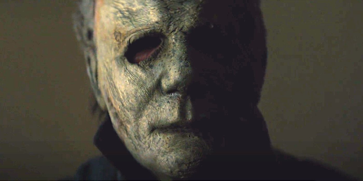 Michael Myers in his filthy old beat up mask looking directly into the camera with eyes like black holes