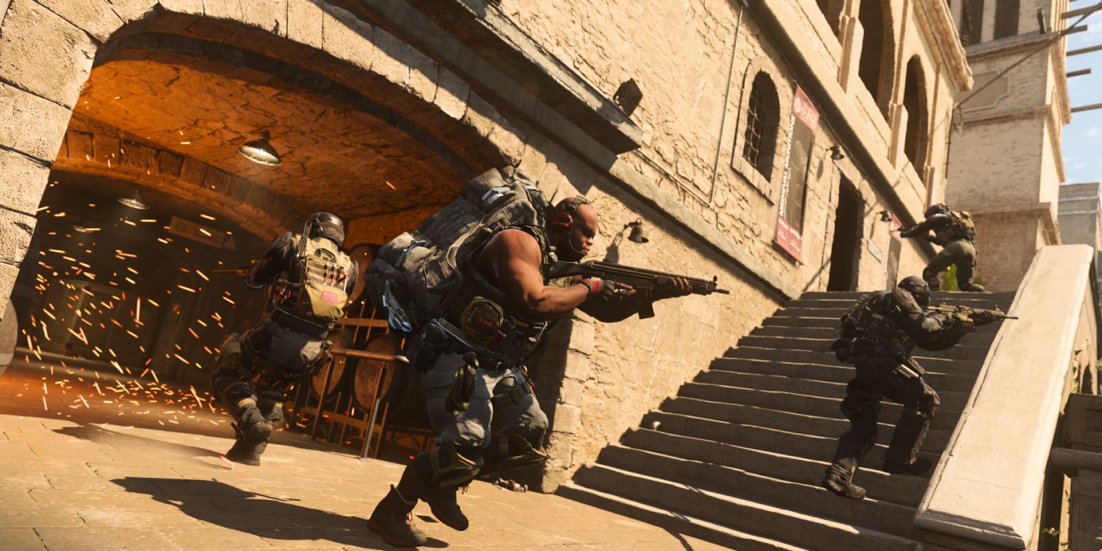 Several Modern Warfare 2 players moving around the exterior of a building.