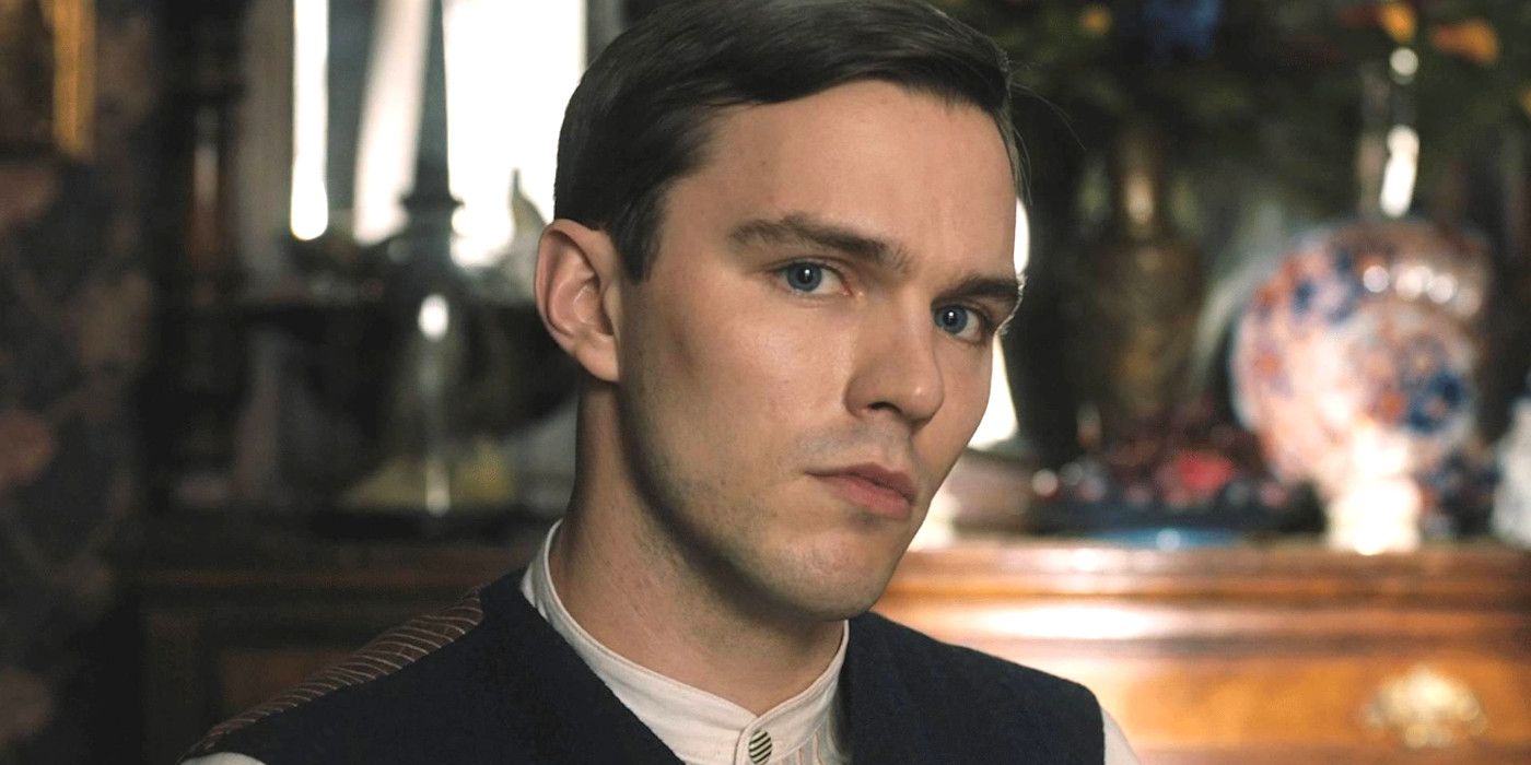 Nicholas Hoult In Tolkien looking directly at camera while surrounded by period set dressing