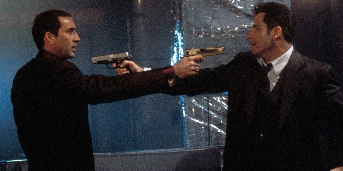 Nicolas Cage and John Travolta hold each other at gunpoint in Face Off