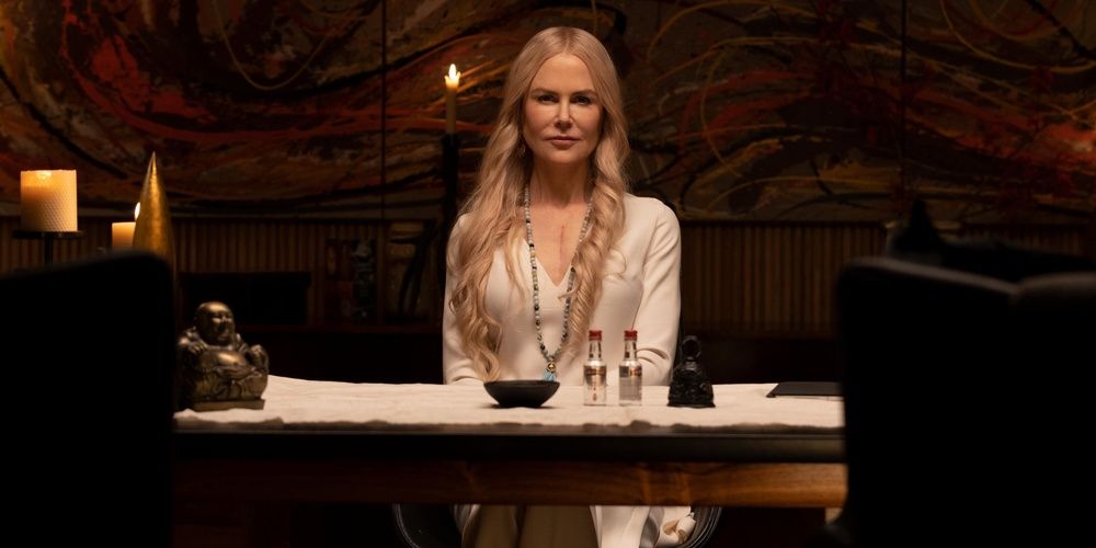 Nicole Kidman sits by a desk in Nine Perfect Strangers