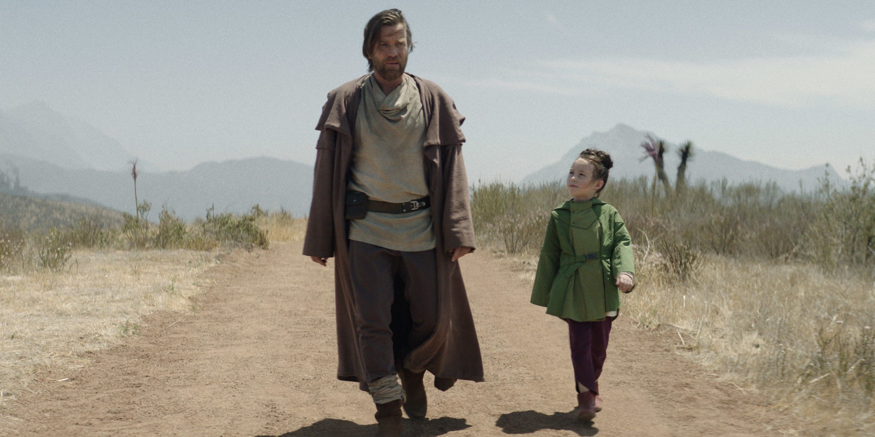 Obi-Wan and Leia walk down a dusty road in Obi-Wan Kenobi