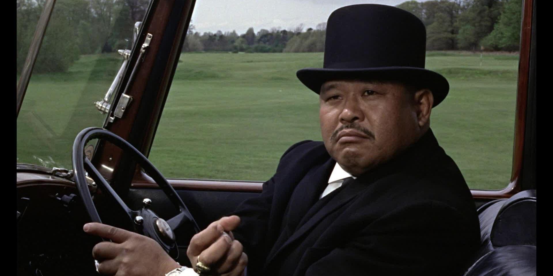 Oddjob driving a car in Goldfinger