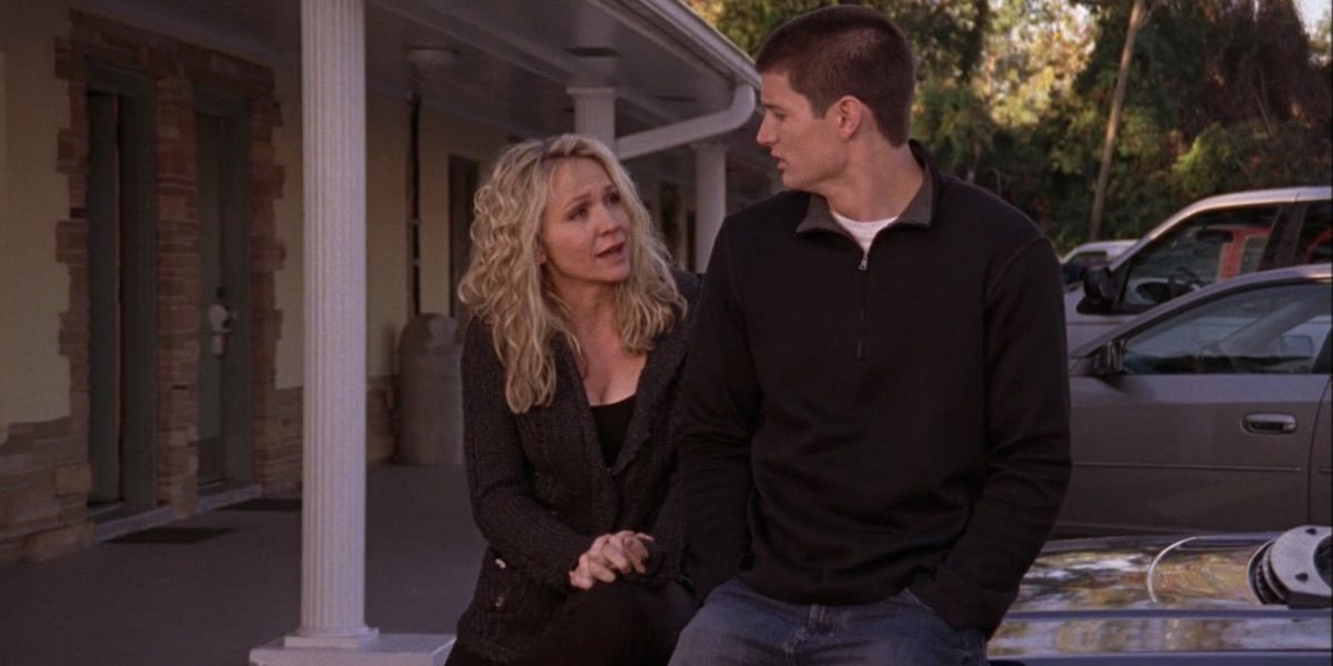 Deb and Nathan sit on a car from One Tree Hill