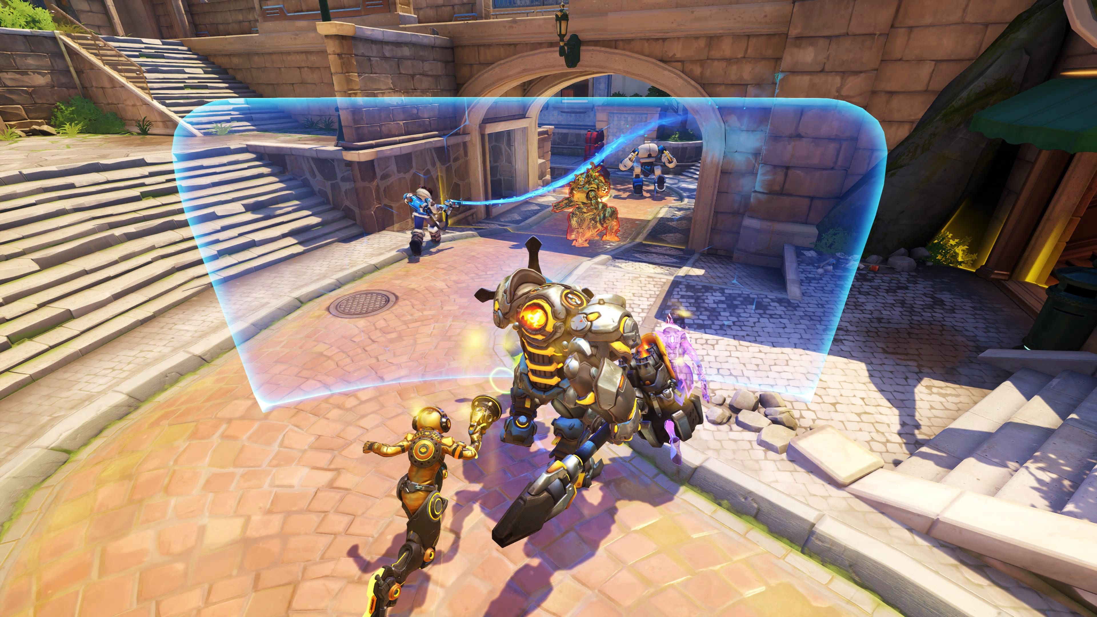 Equipe de blindagem Reinhardt de Overwatch 2 com campo de barreira em avanço