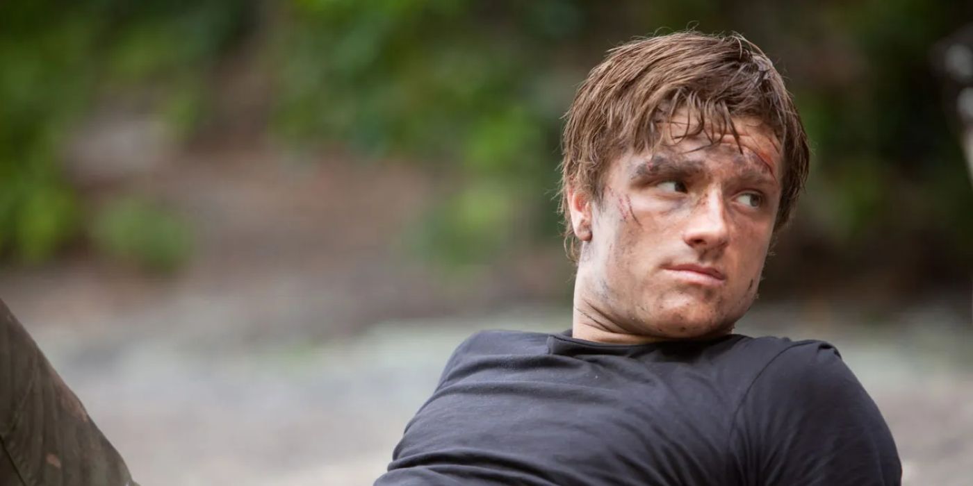 Peeta sitting on the ground in The Hunger Games