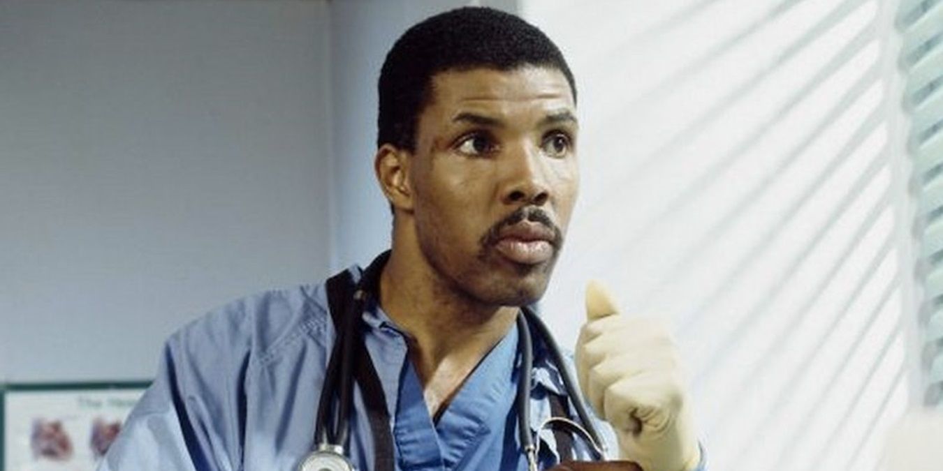 Peter Benton putting on gloves in ER