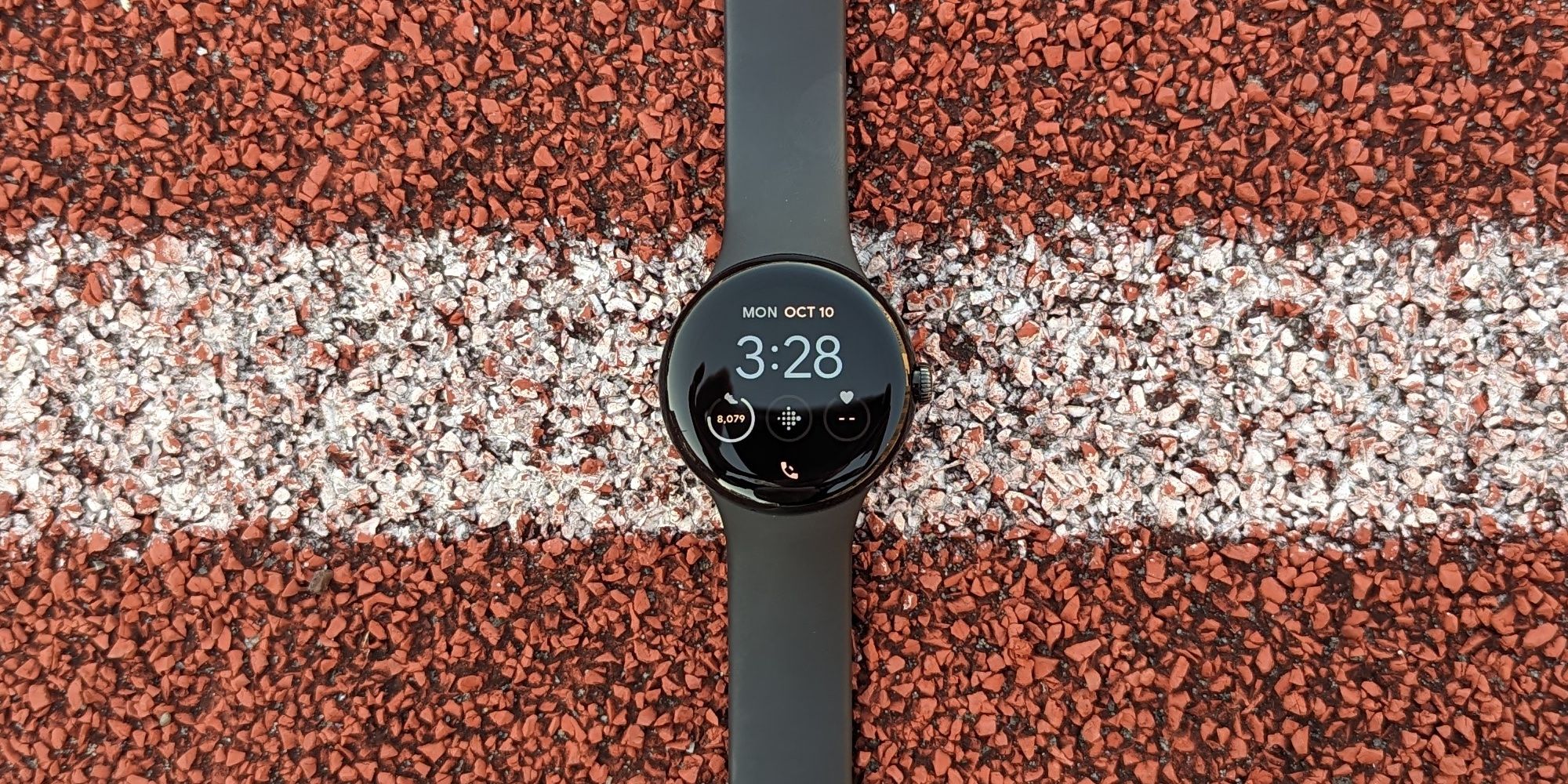 Pixel Watch on a running track. 