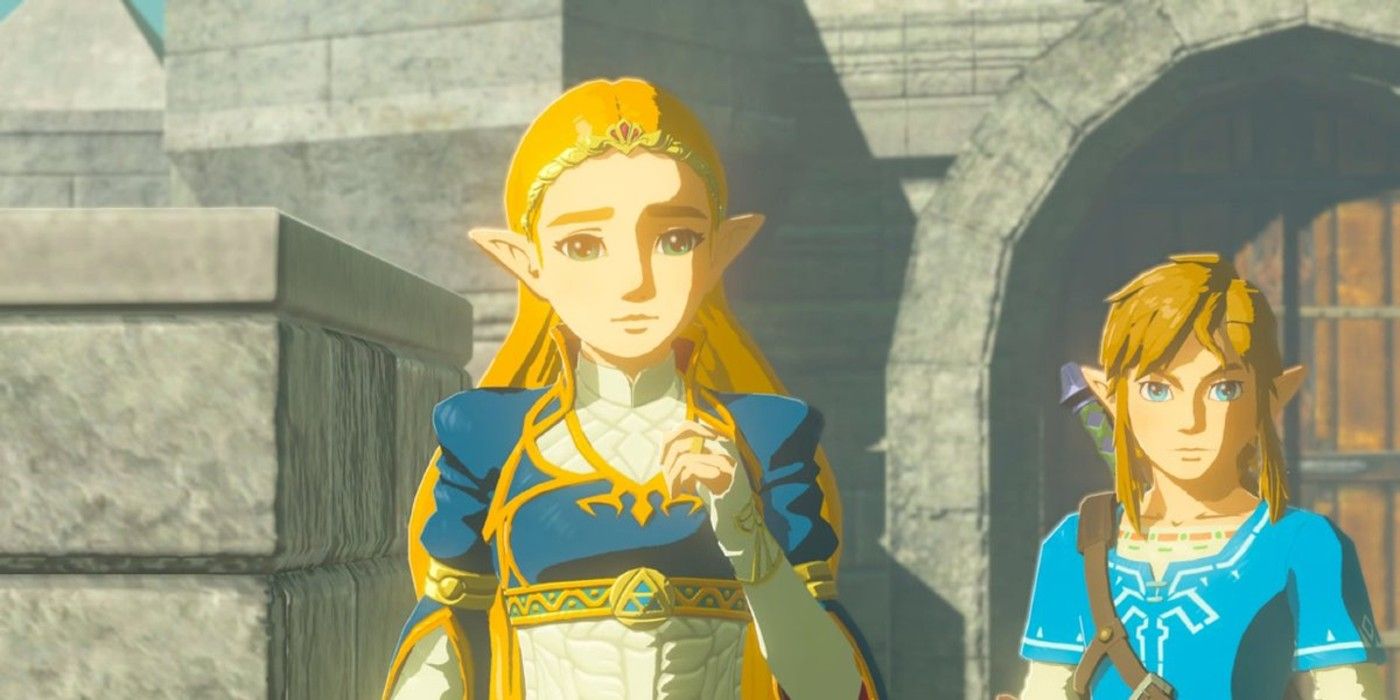 Princess Zelda wearing her blue royal dress in The Legend of Zelda: Breath of the Wild stares at camera with a tender expression on her face while link stands slightly behind her