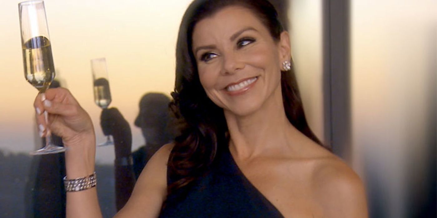 Heather DuBrow lifting up a glass of champagne on RHOC