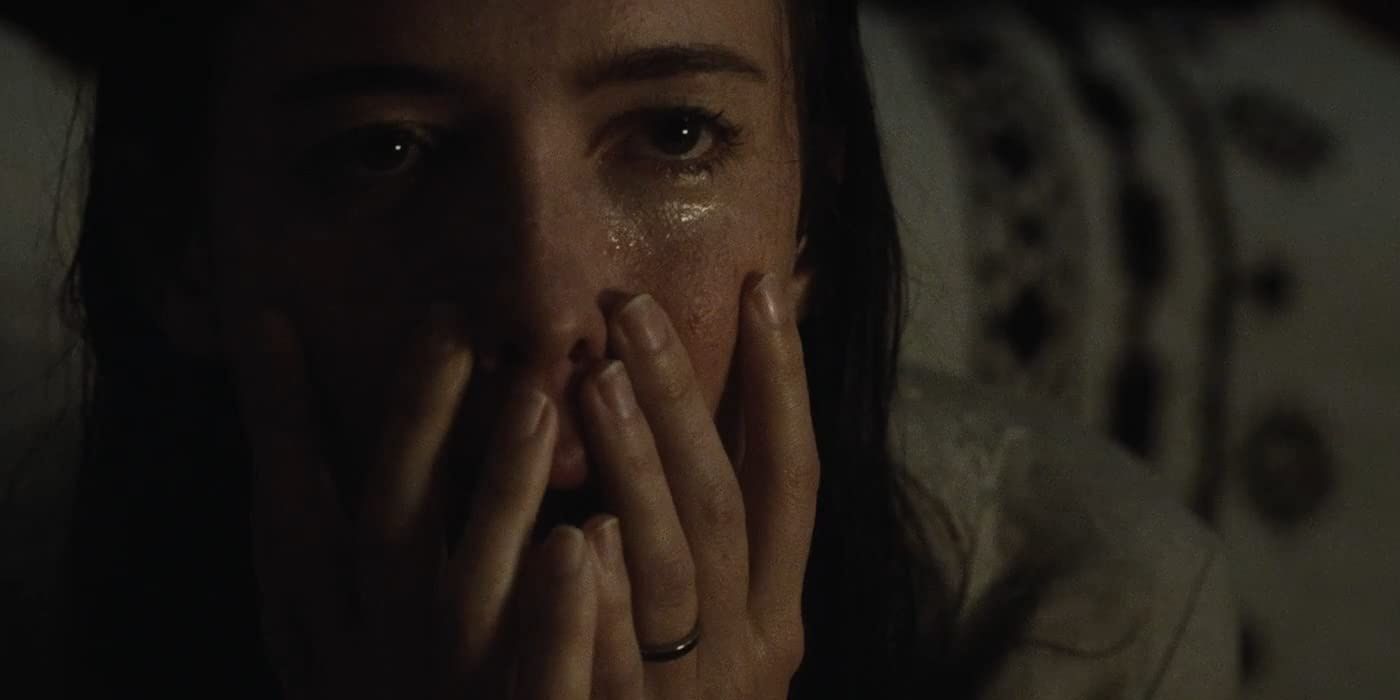 Rebecca Hall touches her face in The Night House 