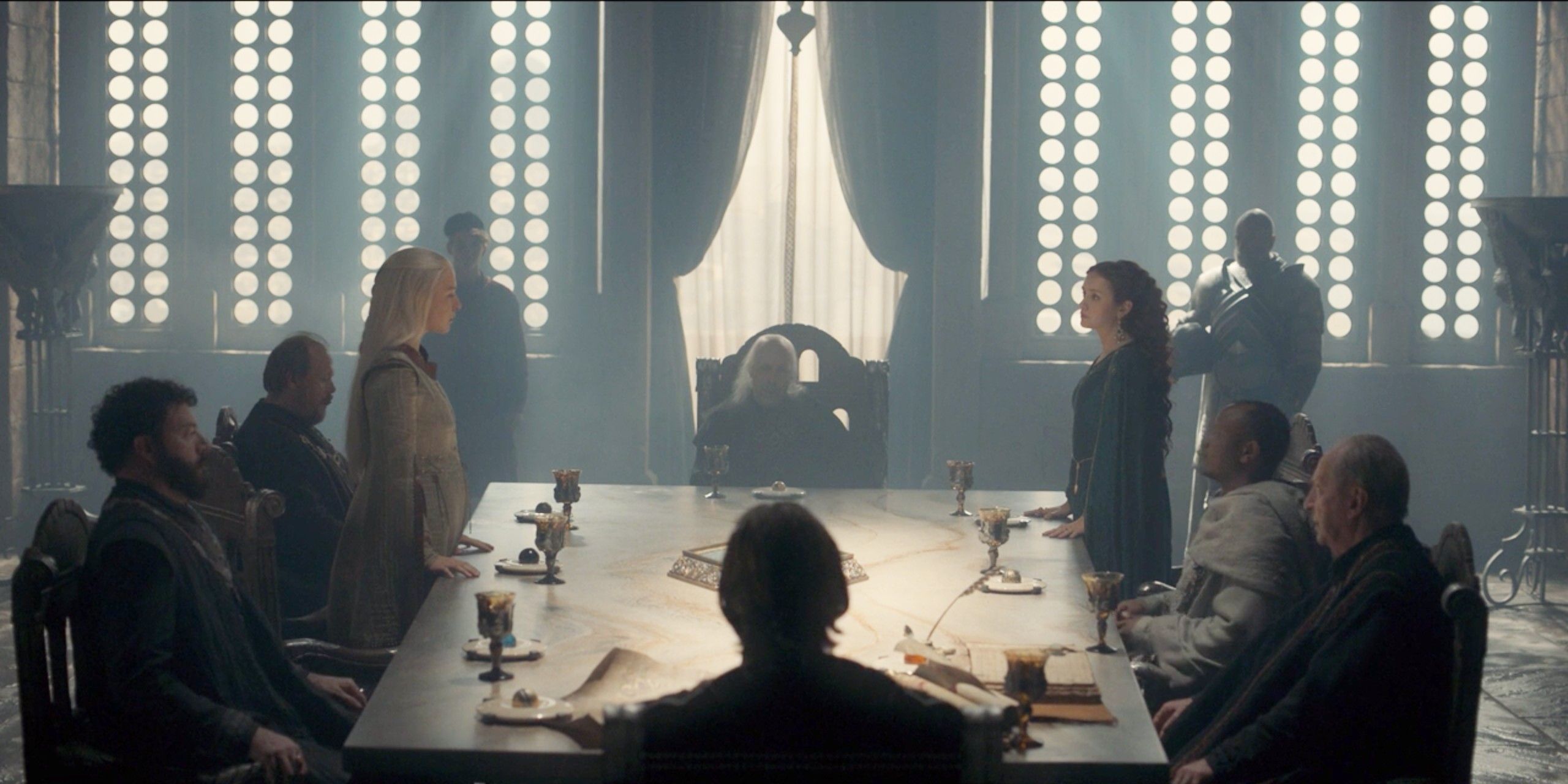 Rhaenyra and Alicent standing on opposite sides of Viserys on House of the Dragon