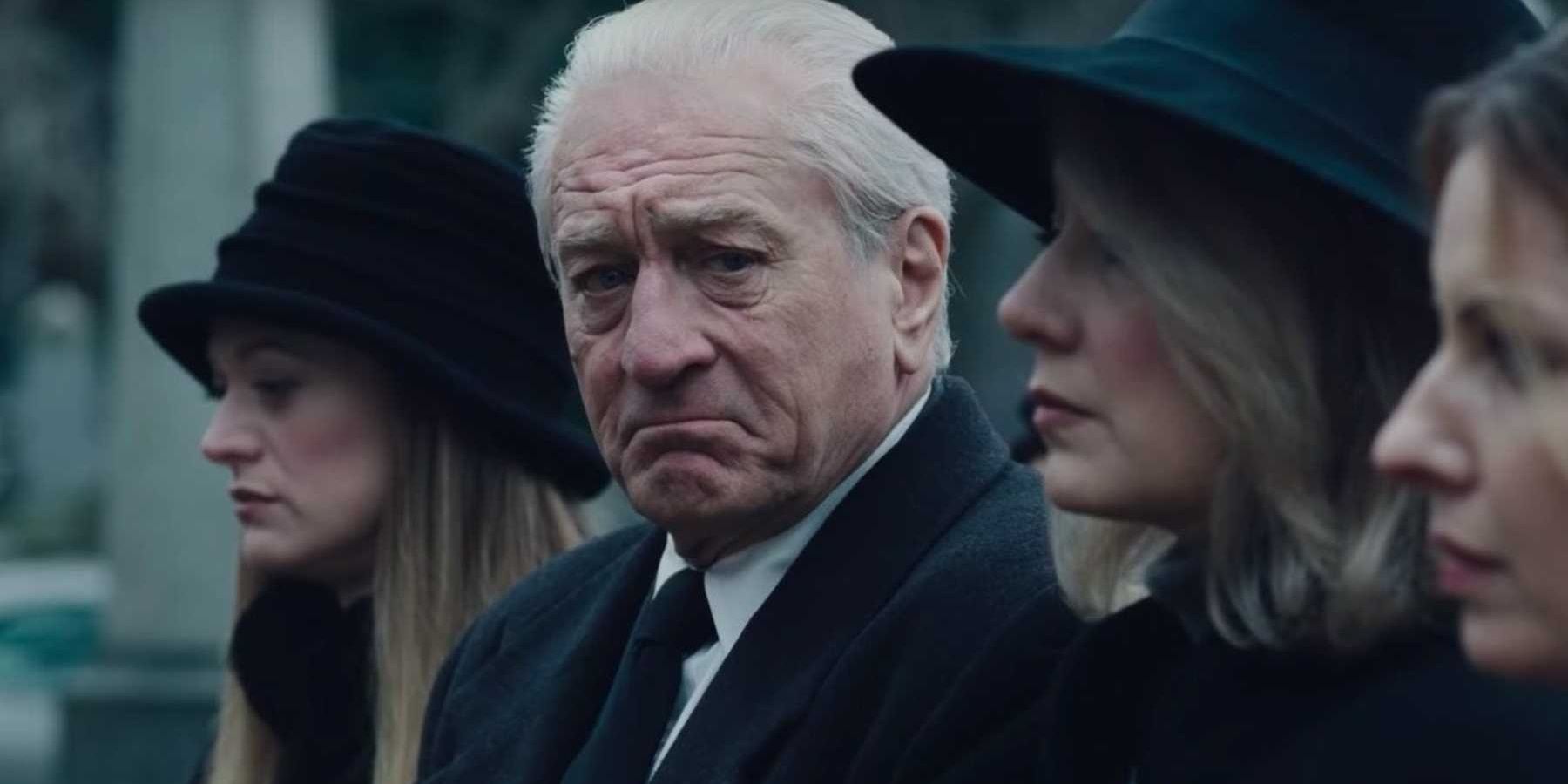 Frank Sheeran looking at someone at a funeral in The Irishman