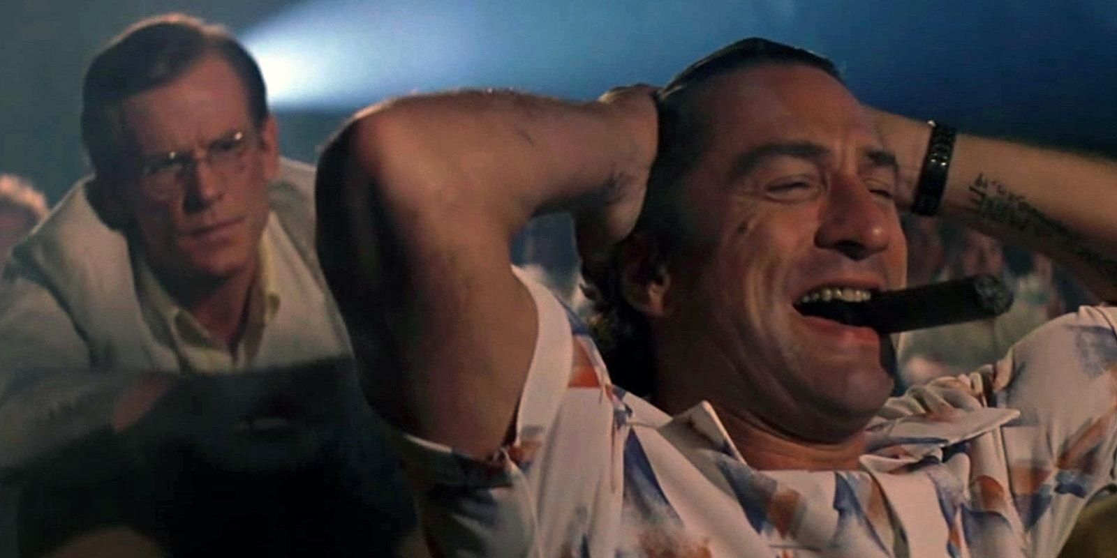 Robert De Niro laughing in a movie theater in Cape Fear