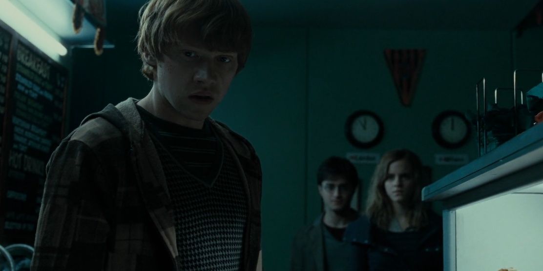 Ron looks down while Harry and Hermione watch in Deathly Hallows Part 1
