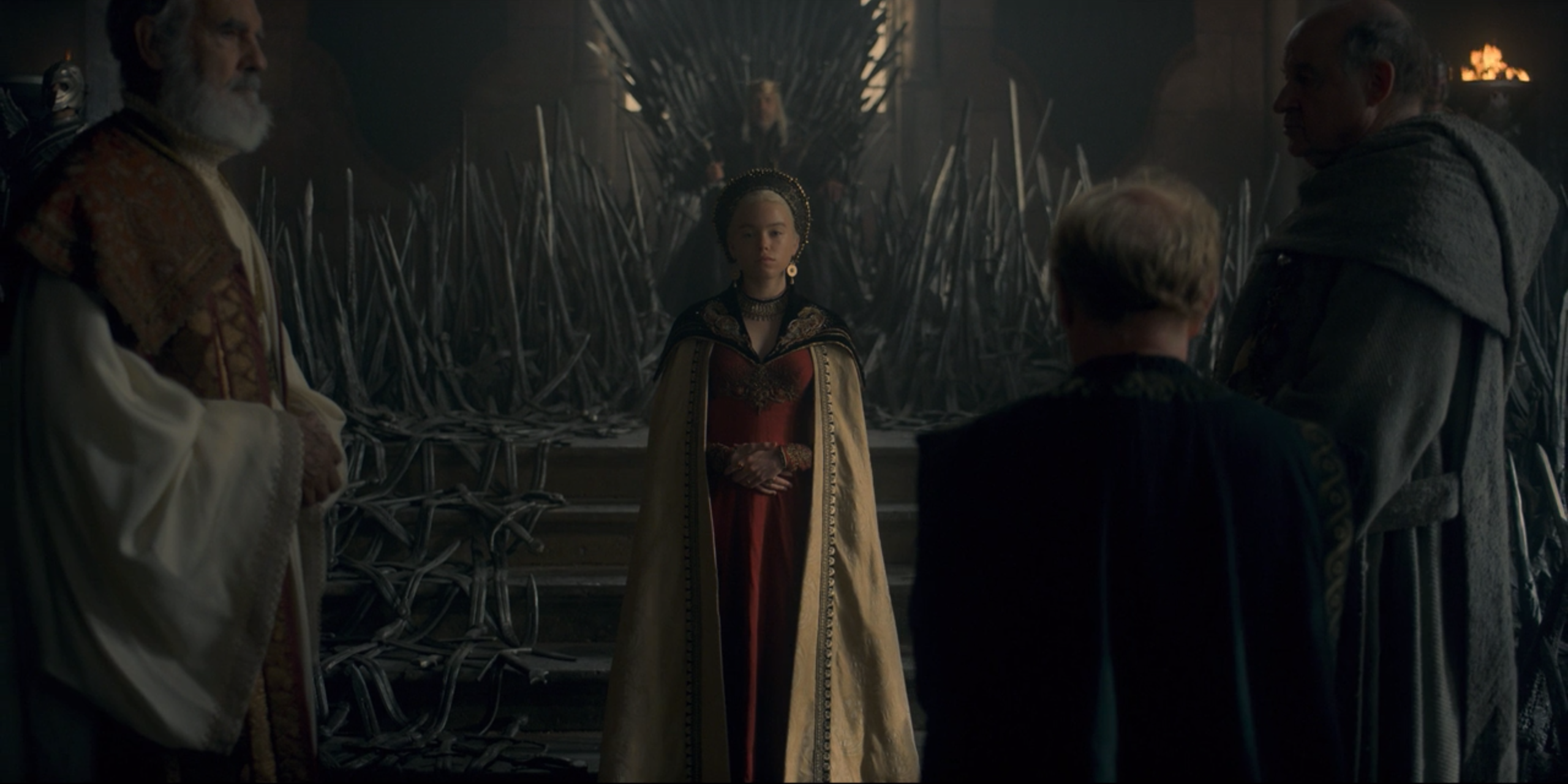 Rhaenyra in a ceremonial gown, with King Viserys in the background and lords on their knees before her in House of the Dragon