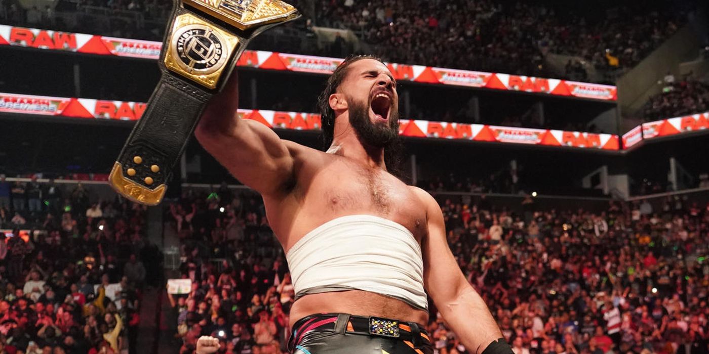 Seth Rollins lifts the United States Championship after beating Bobby Lashley.