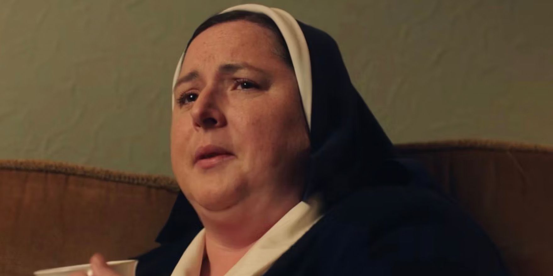 Sister Michael holds a mug of tea at a wake in Derry Girls