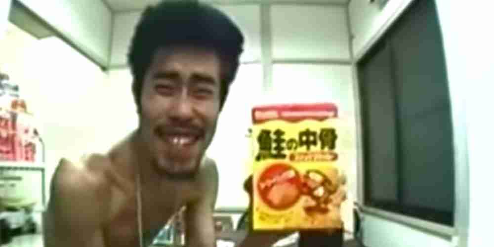 A Japanese comedian eats food while naked in an apartment.