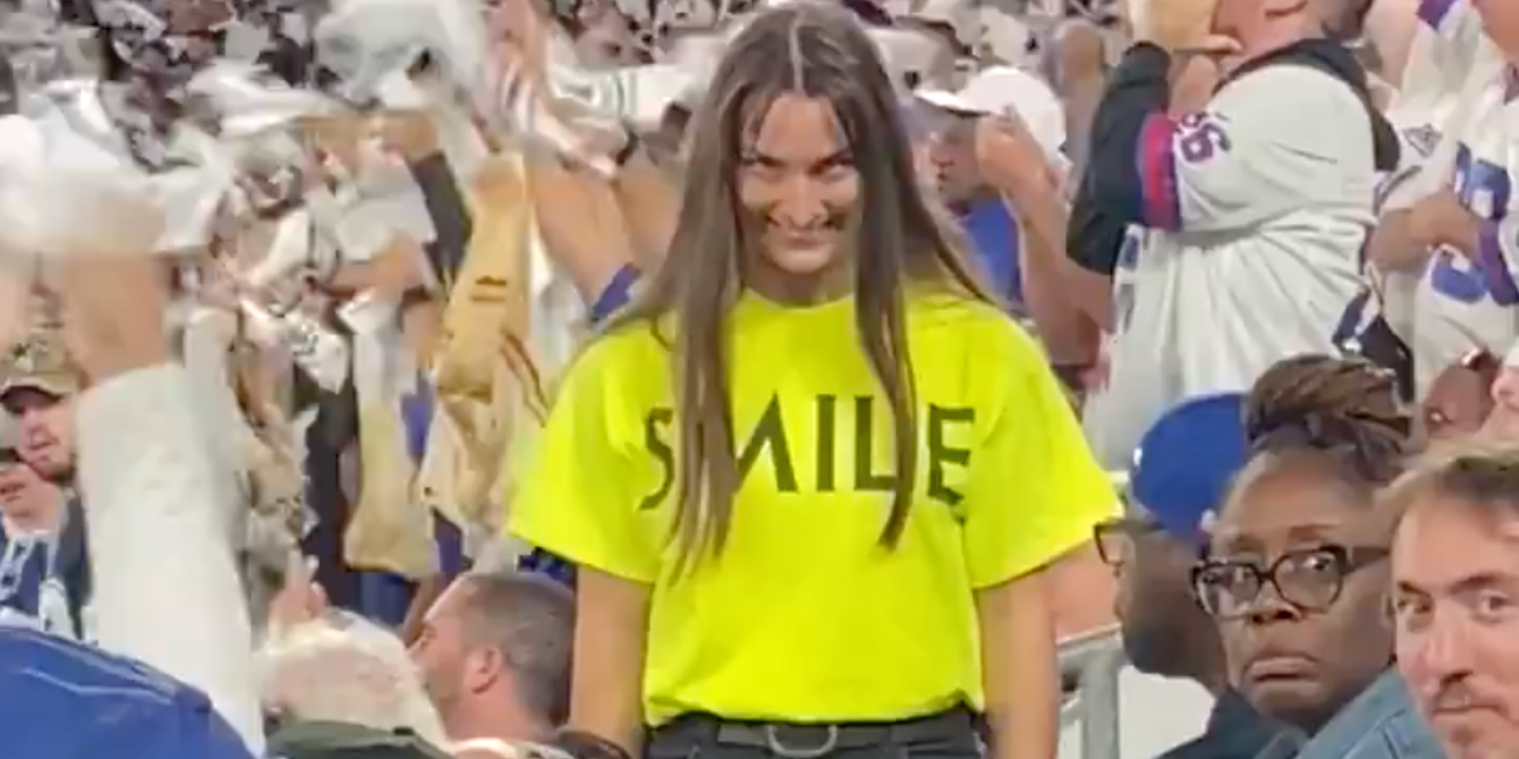 woman smiling creepily in crowd for Smile