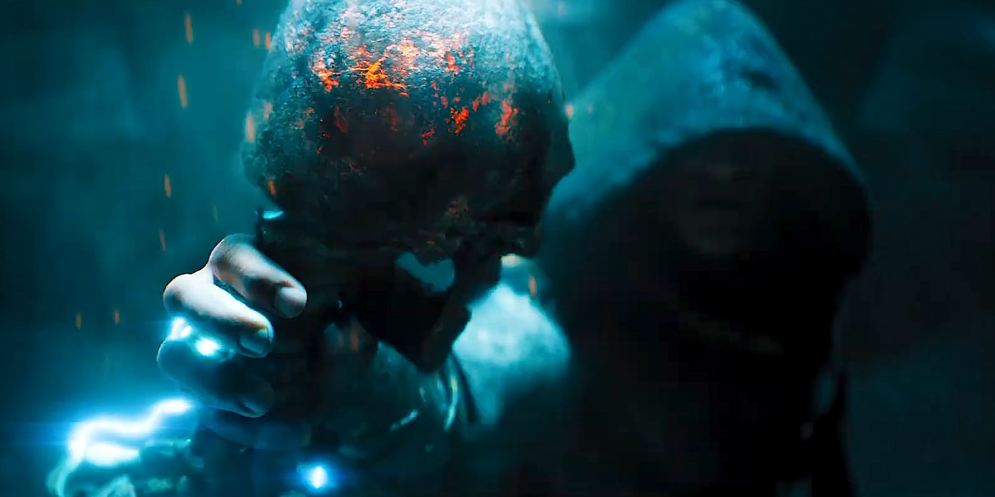 Teth Adam holding the charred skeleton of a mercenary in his hand in Black Adam (2022)