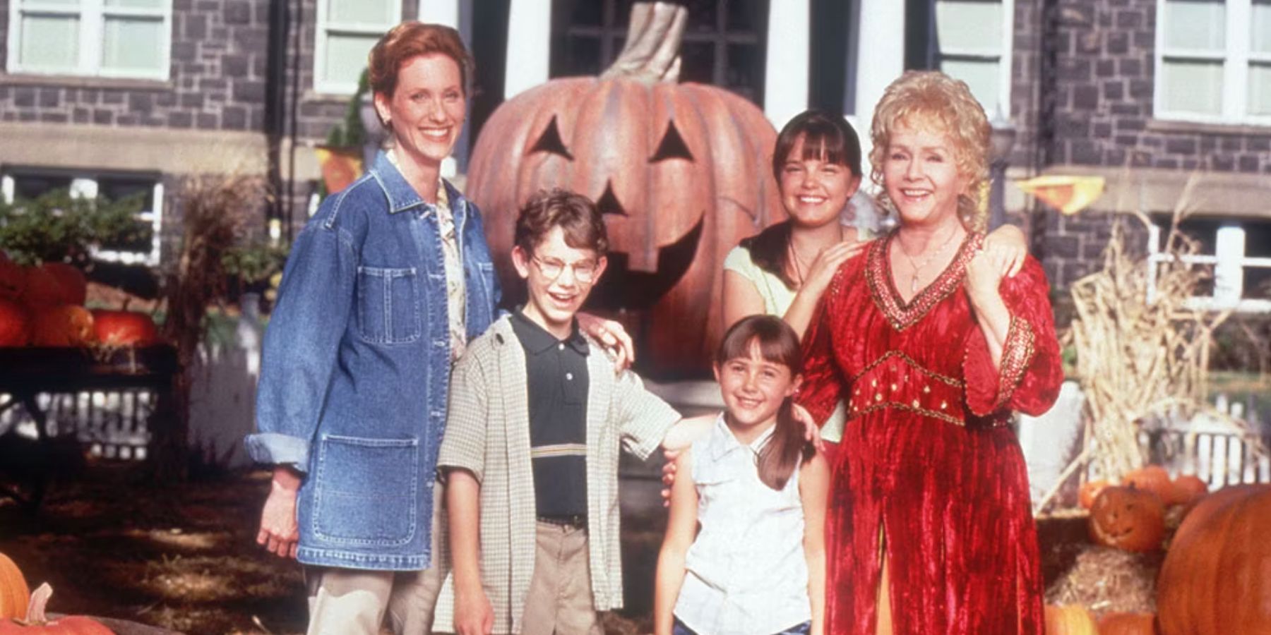 The Cromwell-Piper family in front of a pumpkin patch in Halloweentown