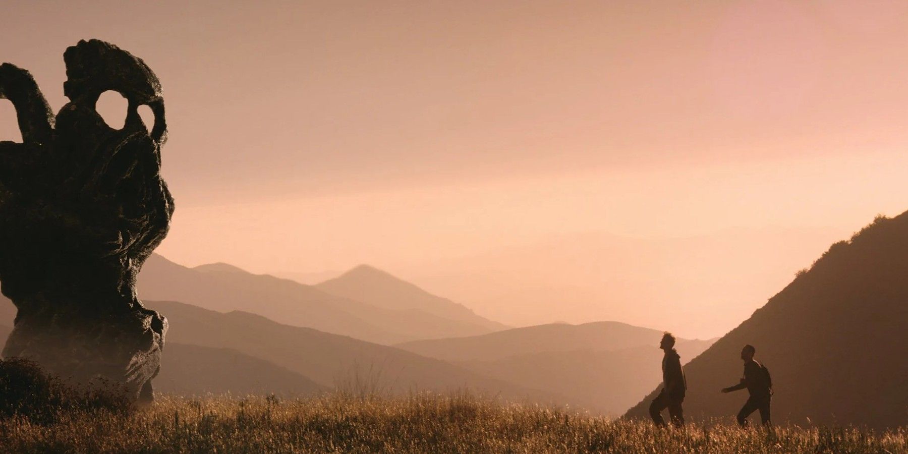 Justin and Aaron walking up a hill to a sculpture in The Endless