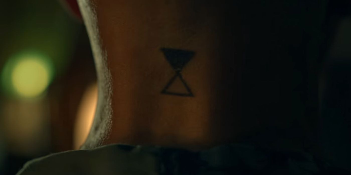 Dr Stanton's neck tattoo of an hourglass