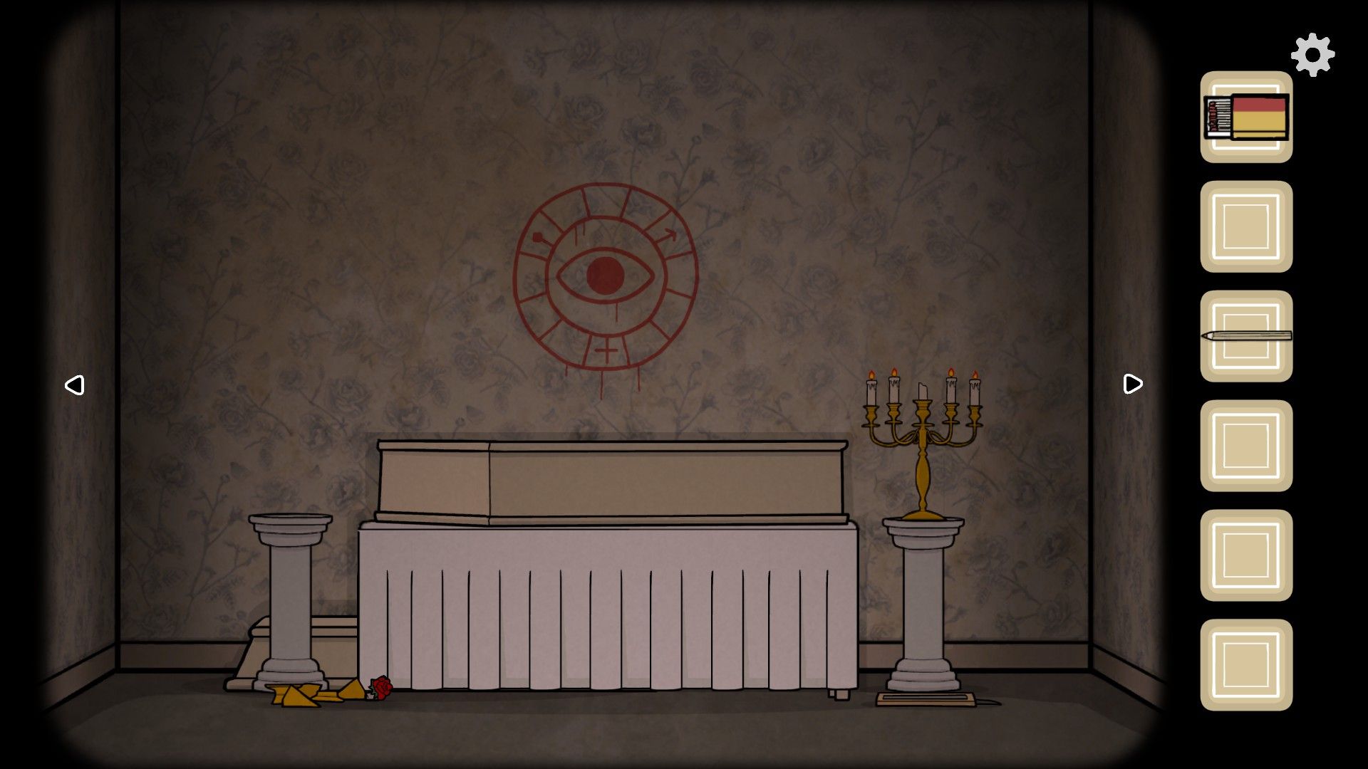 The Past Within's casket and an eye in a circle drawn in red on the wall.