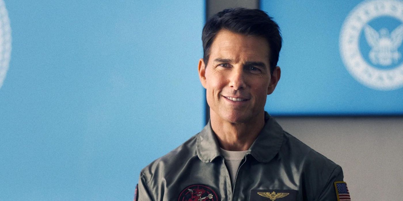 Tom Cruise smiling as he speaks to the Top Gun officers in Top Gun: Maverick