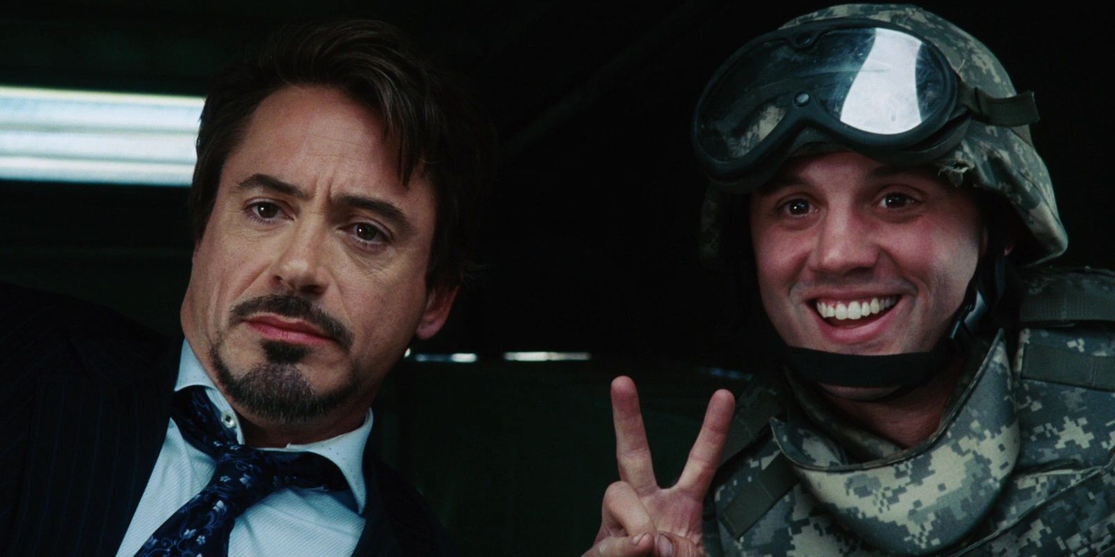 Tony takes a photo with a soldier in Iron Man