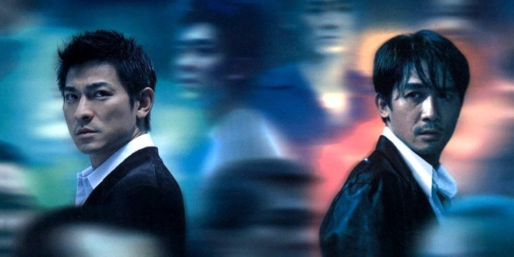 Two men stand apart from each other in a crowd in Internal Affairs