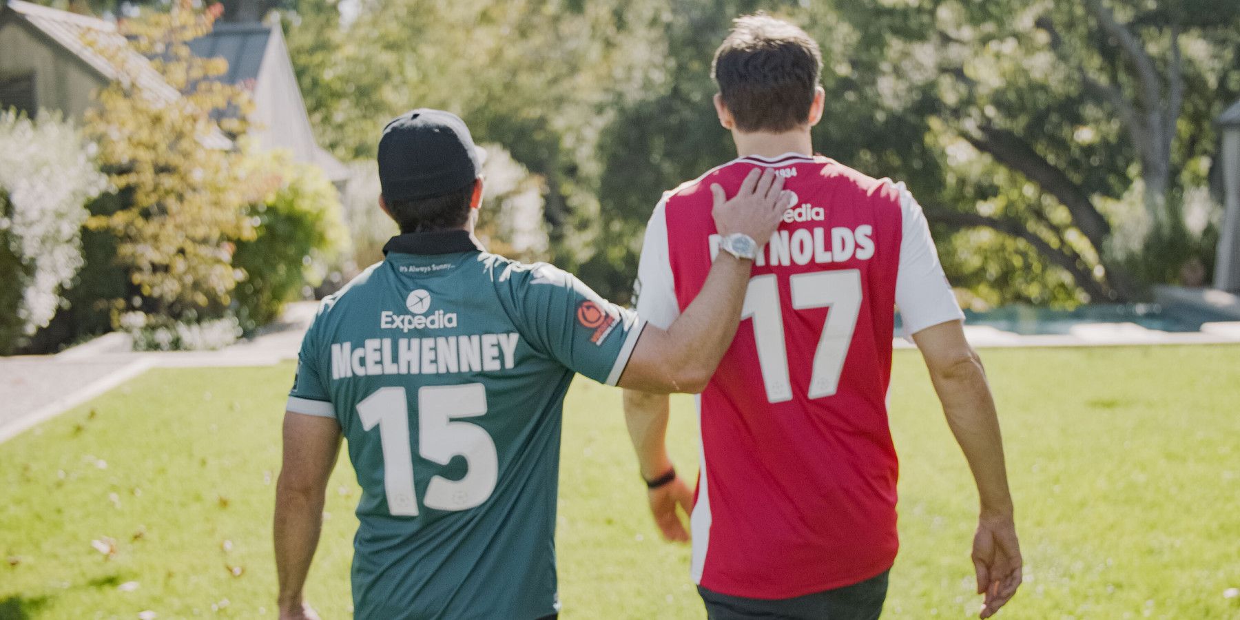 Rob McElhenny and Ryan Reynolds walk on a soccer pitch in Welcome to Wrexham