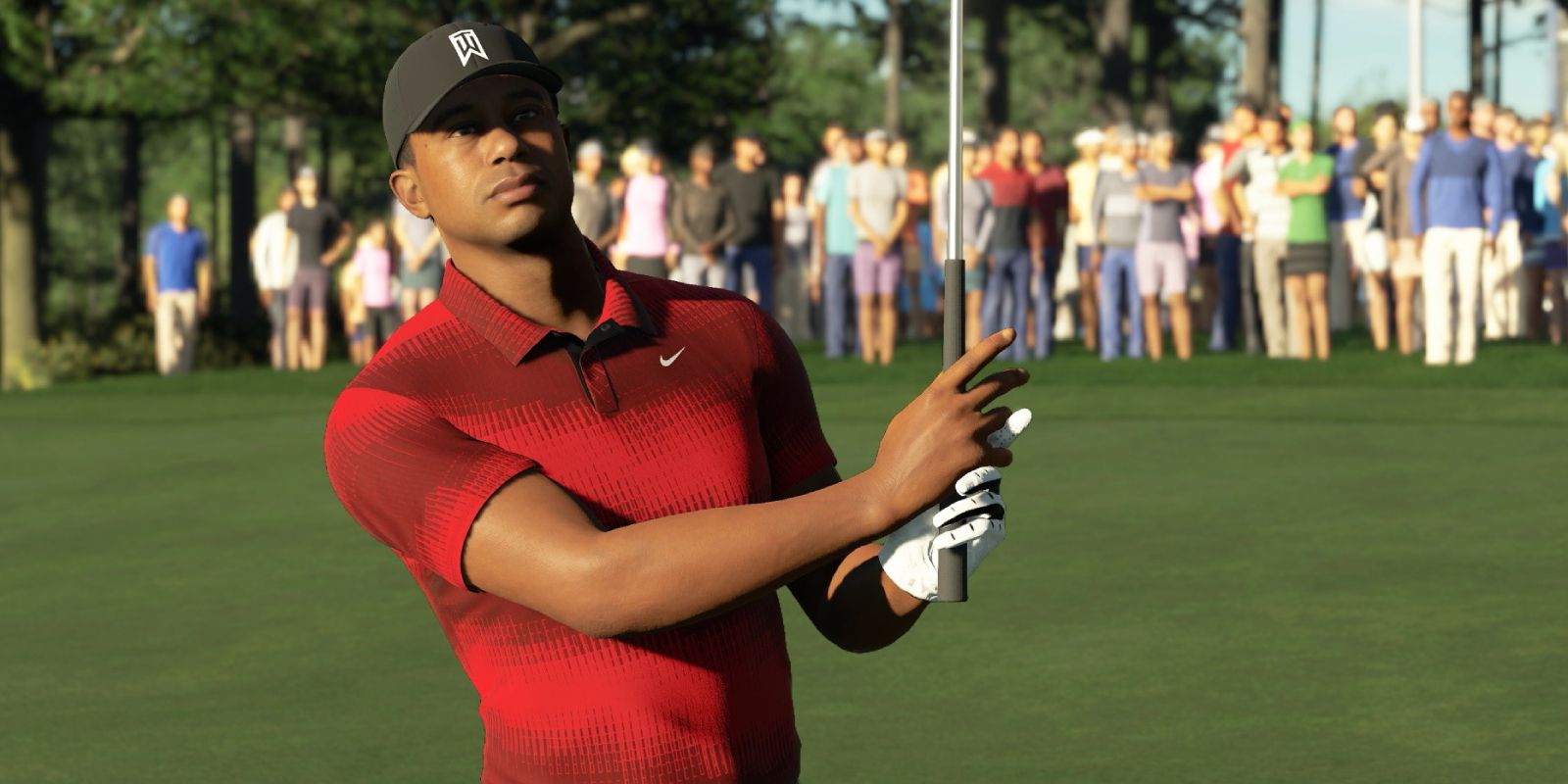 In PGA Tour 2K23, a golfer stands ready with his club.