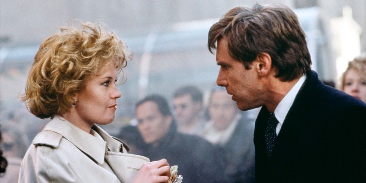 Melanie Griffith and Harrison Ford looking intensely in Working Girl